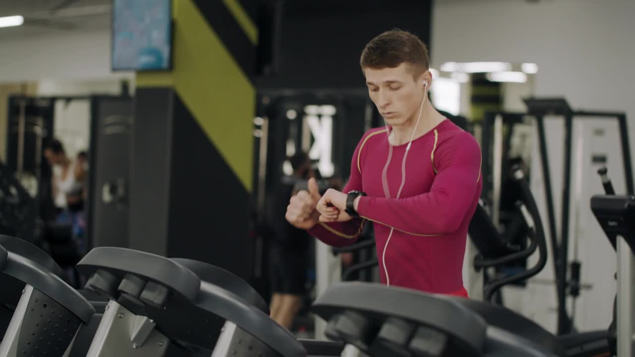 Stock Video Man On Treadmill In Gym Checks Timer On Watc Animated Wallpaper
