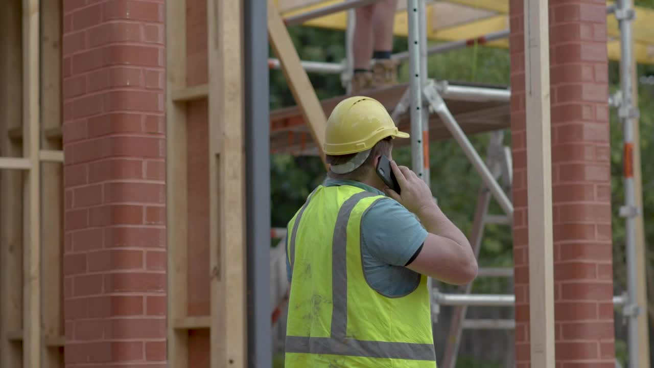 Stock Video Man On The Phone Near A Construction Sit Animated Wallpaper