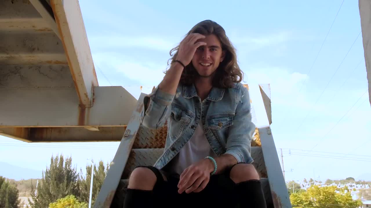 Stock Video Man On Stairs Of Graffitied Buildin Animated Wallpaper