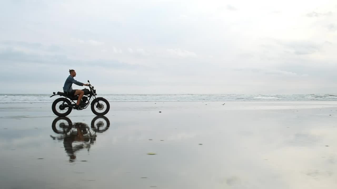 Stock Video Man On Motorcycle On The Seashor Animated Wallpaper