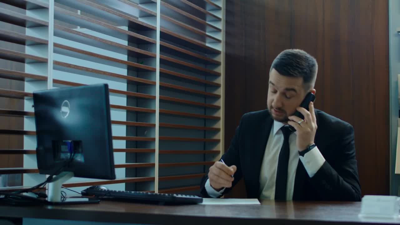 Stock Video Man On A Phone Call At His Des Animated Wallpaper