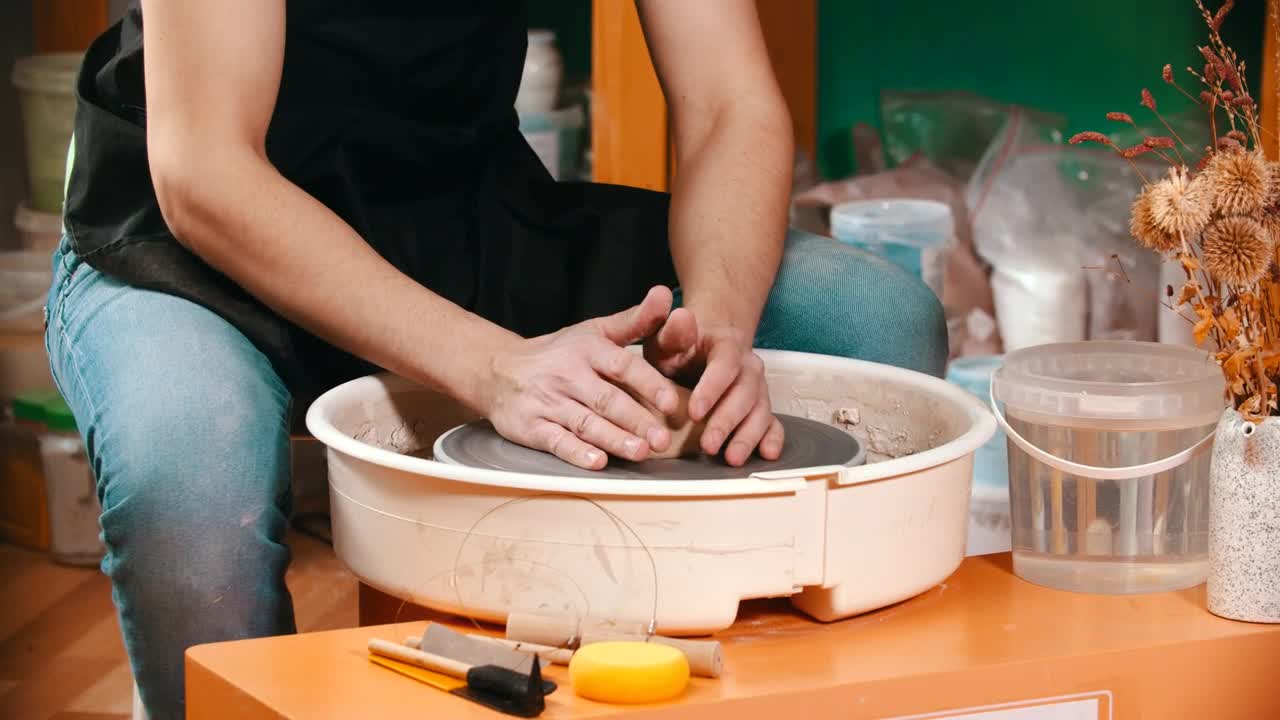 Stock Video Man Molding Clay On The Spinning Whee Animated Wallpaper