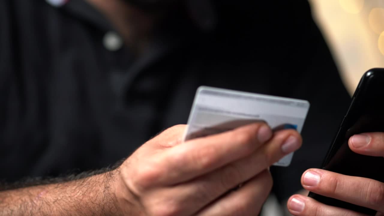 Stock Video Man Making A Transaction On His Smartphone With His Car Animated Wallpaper