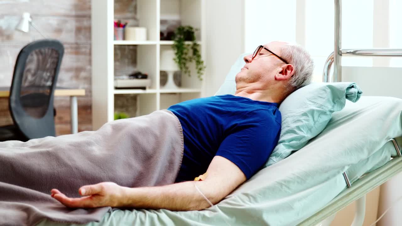 Stock Video Man Lying In Hospital Bed Receiving Treatmen Animated Wallpaper