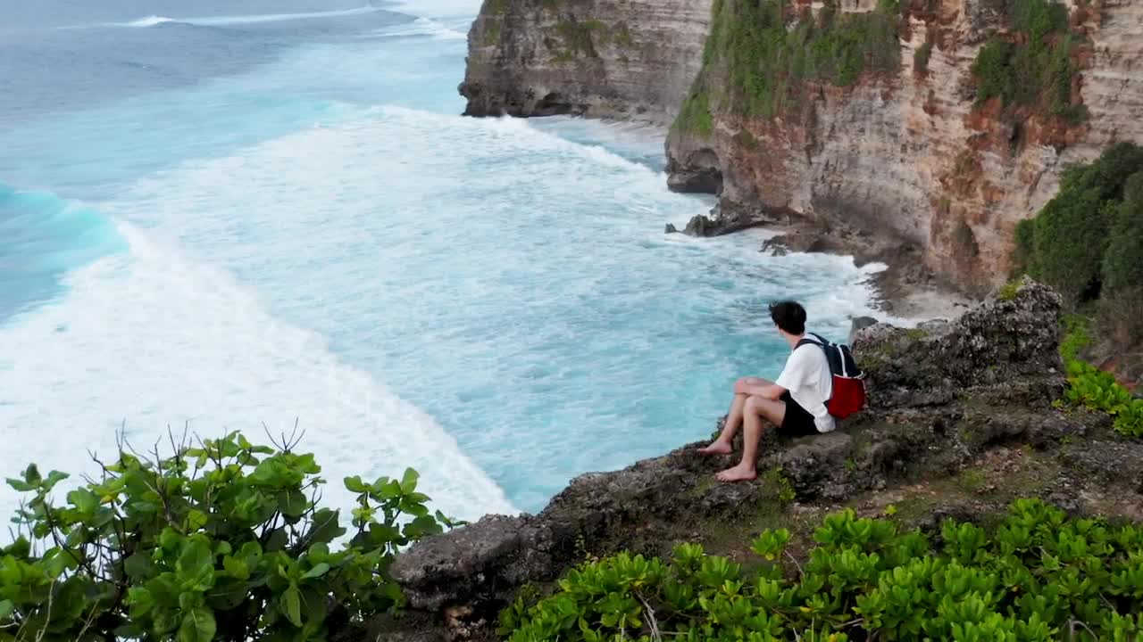 Stock Video Man Looking Out To Sea From A High Clif Animated Wallpaper