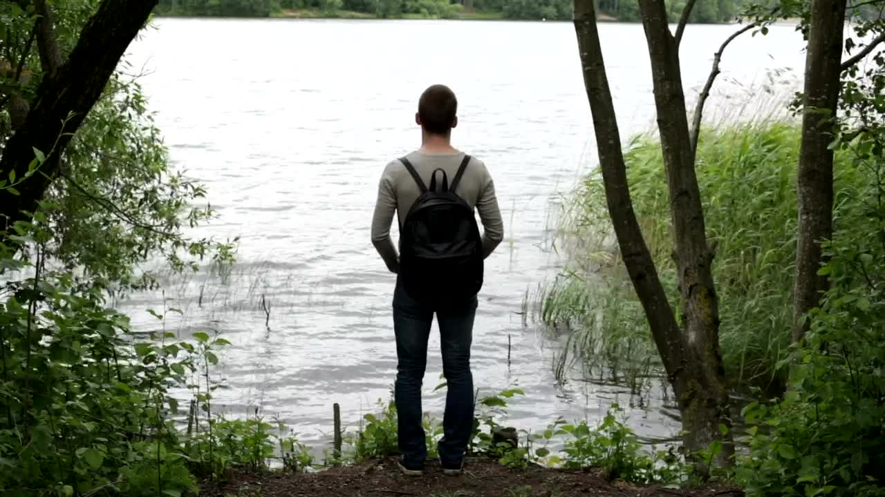 Stock Video Man Looking Out Across A Lak Animated Wallpaper