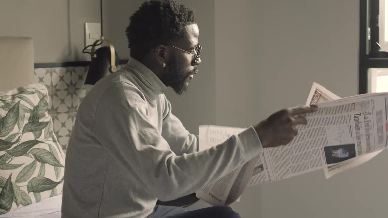 Stock Video Man Looking For An Interesting Reading In A Newspape Animated Wallpaper