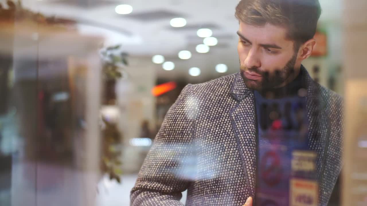 Stock Video Man Looking At The Sideboard Of A Clothing Stor Animated Wallpaper