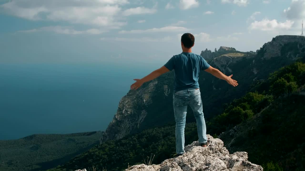 Stock Video Man Looking At The Horizon Raises His Hand Animated Wallpaper
