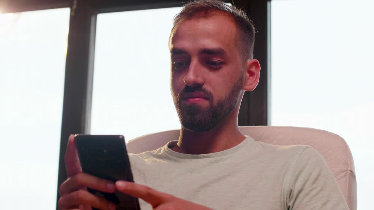 Stock Video Man Looking At His Cell Phone While Smilin Animated Wallpaper