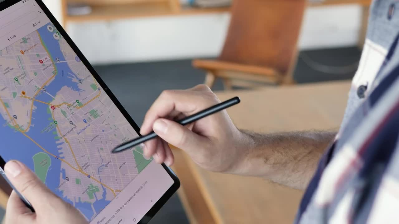 Stock Video Man Locating An Area On A Map On A Table Animated Wallpaper