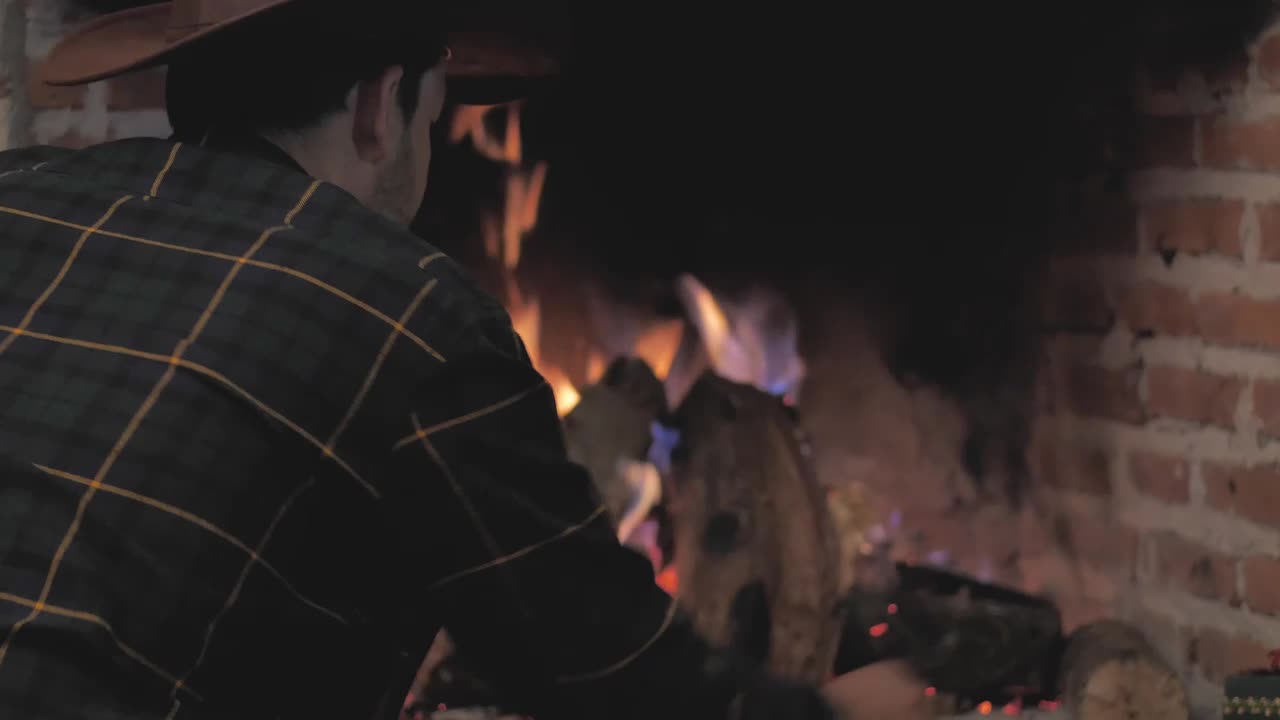 Stock Video Man Lighting Fireplace With Firewoo Animated Wallpaper