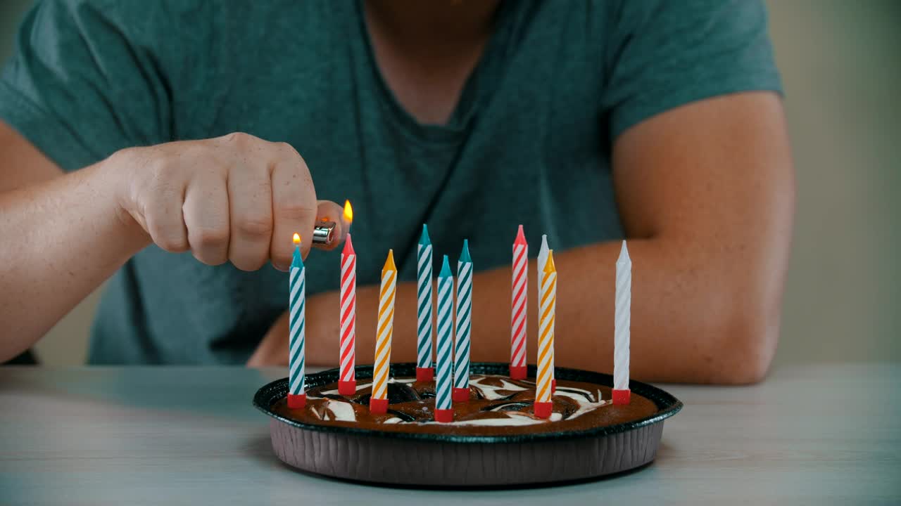 Stock Video Man Lighting Candles On A Small Birthday Cak Animated Wallpaper