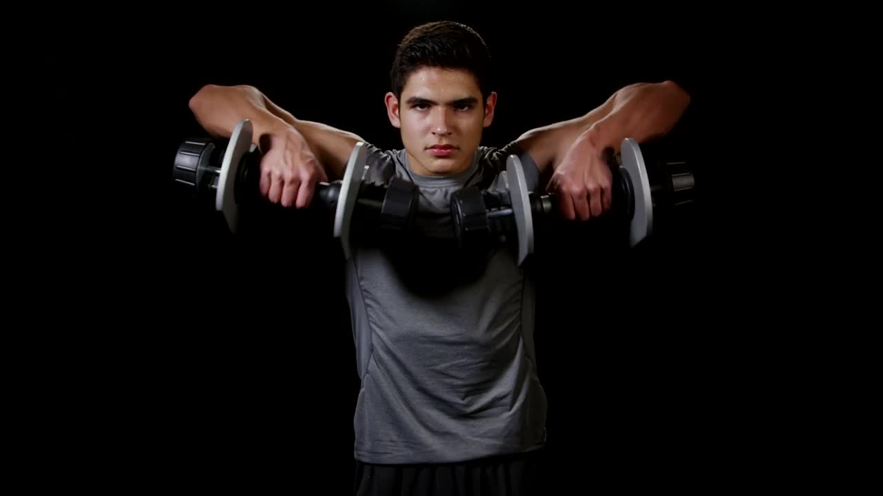 Stock Video Man Lifting Weights While Standin Animated Wallpaper