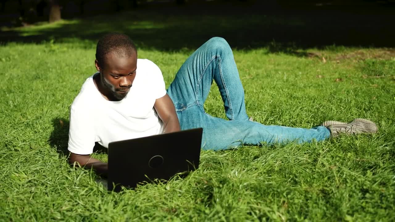 Stock Video Man Learning Online While Relaxing In Par Animated Wallpaper