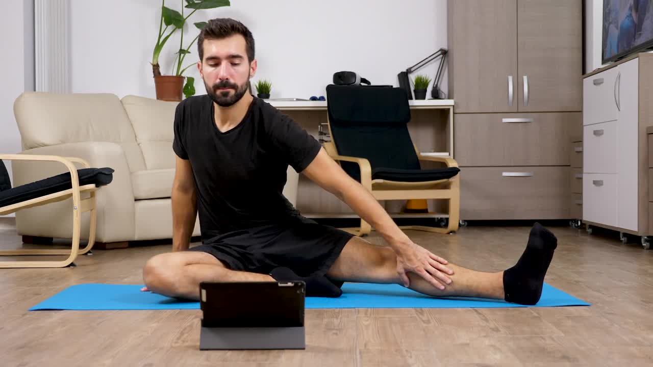 Stock Video Man Learning Exercises From Online Video At Hom Animated Wallpaper