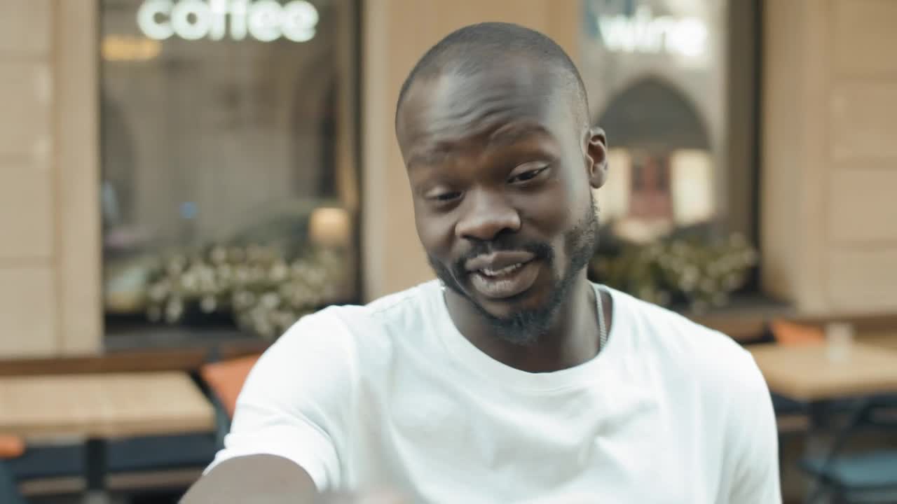 Stock Video Man Laughs At Facebook Video Call Outside Caf Animated Wallpaper