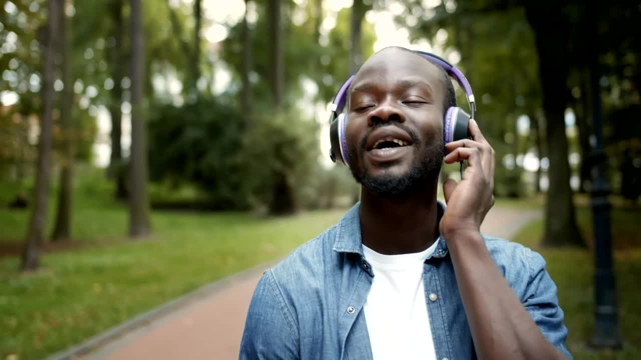 Stock Video Man Inspired By Music While On Walk In Par Animated Wallpaper