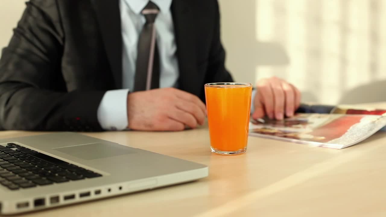 Stock Video Man In Suit Flipping Through A Magazin Animated Wallpaper