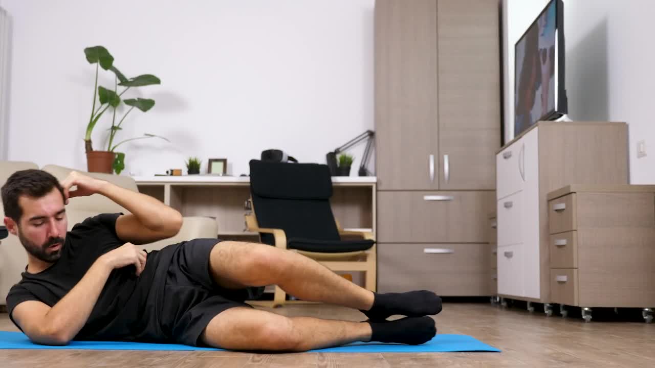 Stock Video Motivated Man Exercises On Floor At Home Live Wallpaper