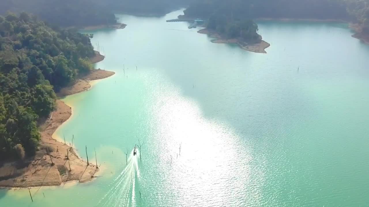 Stock Video Motorboat Sailing In A Bay On A Sunny Day Live Wallpaper