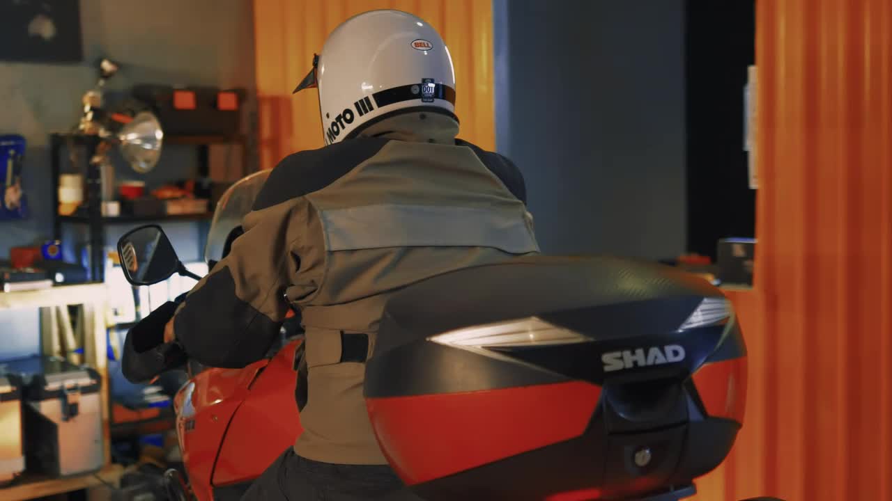 Stock Video Motorcyclist Arriving At A Mechanical Workshop Live Wallpaper