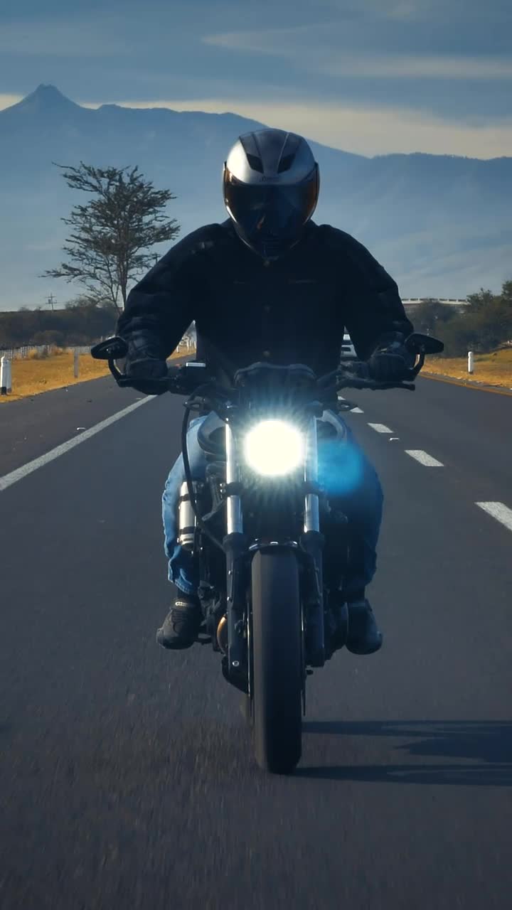 Stock Video Motorcyclist Going Down A Road Seen From The Front Live Wallpaper