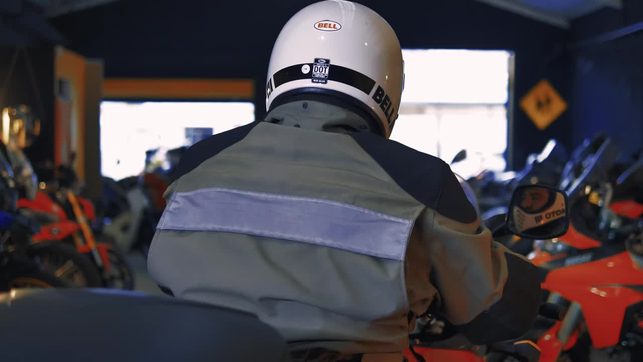 Stock Video Motorcyclist In A Workshop Full Of Motorcycles Live Wallpaper