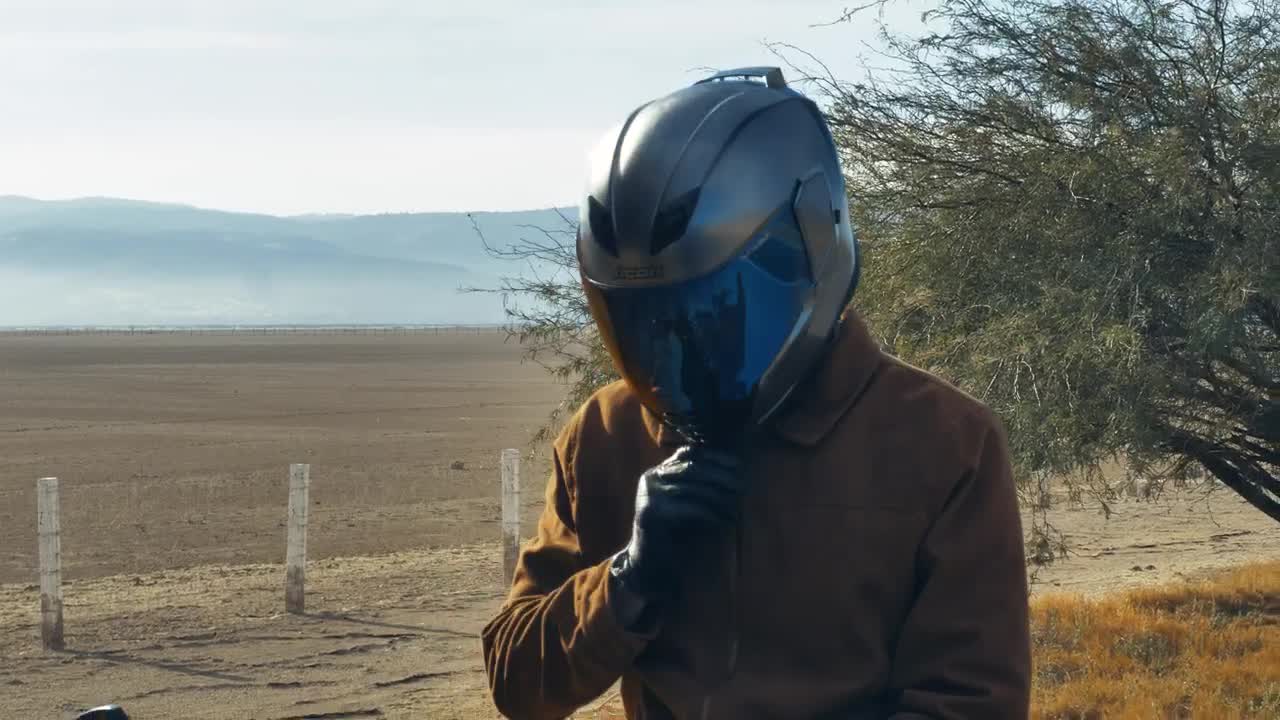 Stock Video Motorcyclist On The Side Of A Road Before Setting Off Live Wallpaper