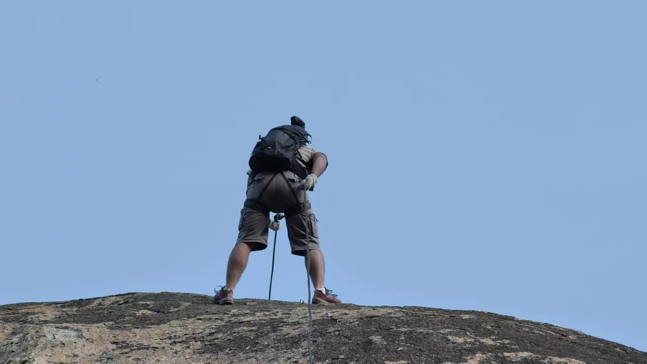 Stock Video Mountaineer Descending A Rocky Slope Live Wallpaper