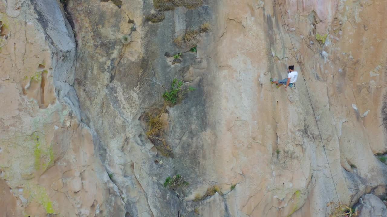 Stock Video Mountaineer Descending From A Large Mountain With A Rope LargeLive Wallpaper
