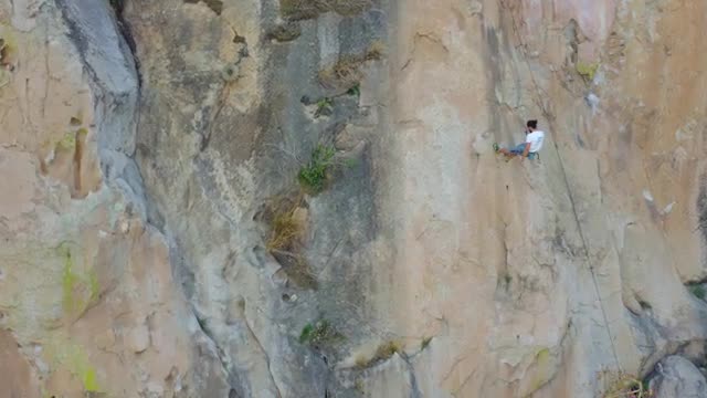 Stock Video Mountaineer Descending From A Large Mountain With A Rope Live Wallpaper