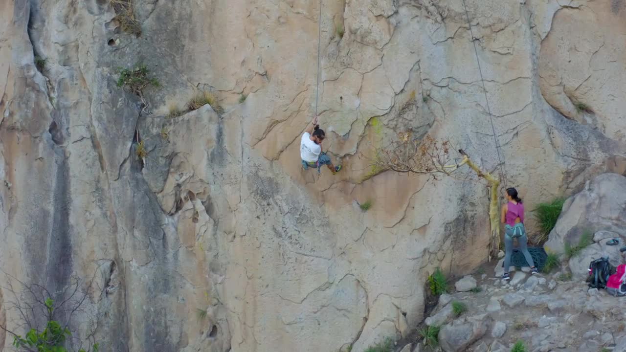 Stock Video Mountaineer Descending From A Mountain With A Rope Live Wallpaper