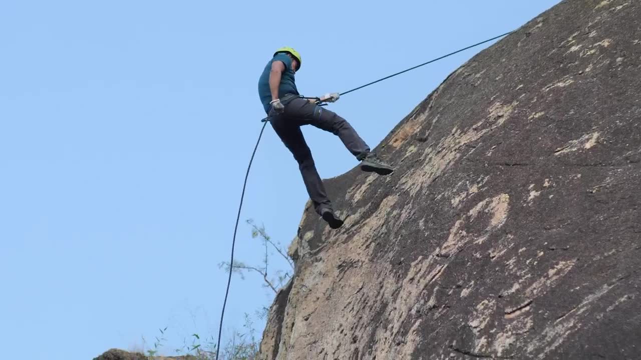 Stock Video Mountaineer Descending From A Rocky Mountain Live Wallpaper