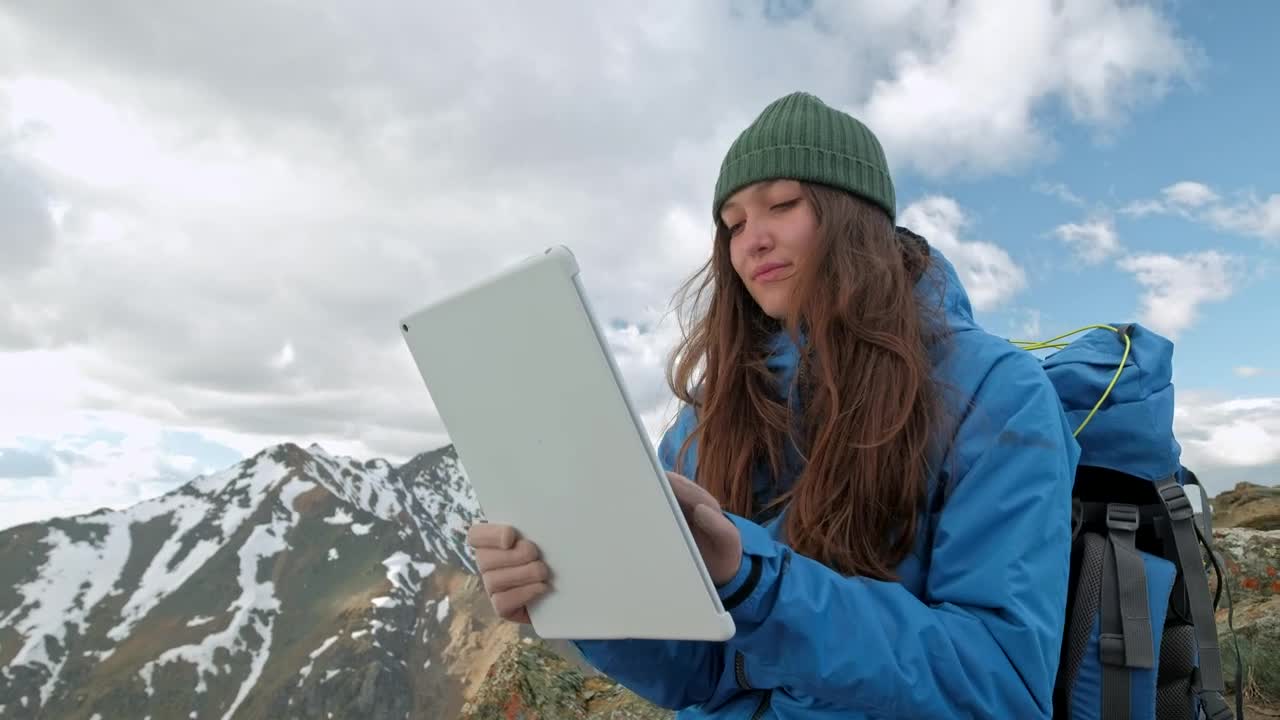 Stock Video Mountaineer Using A Tablet On A Mountain Live Wallpaper