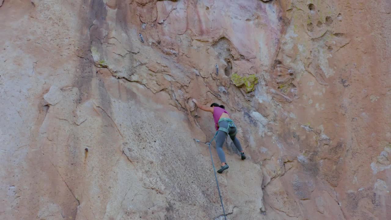 Stock Video Mountaineer Woman Climbing A Huge Mountain Live Wallpaper