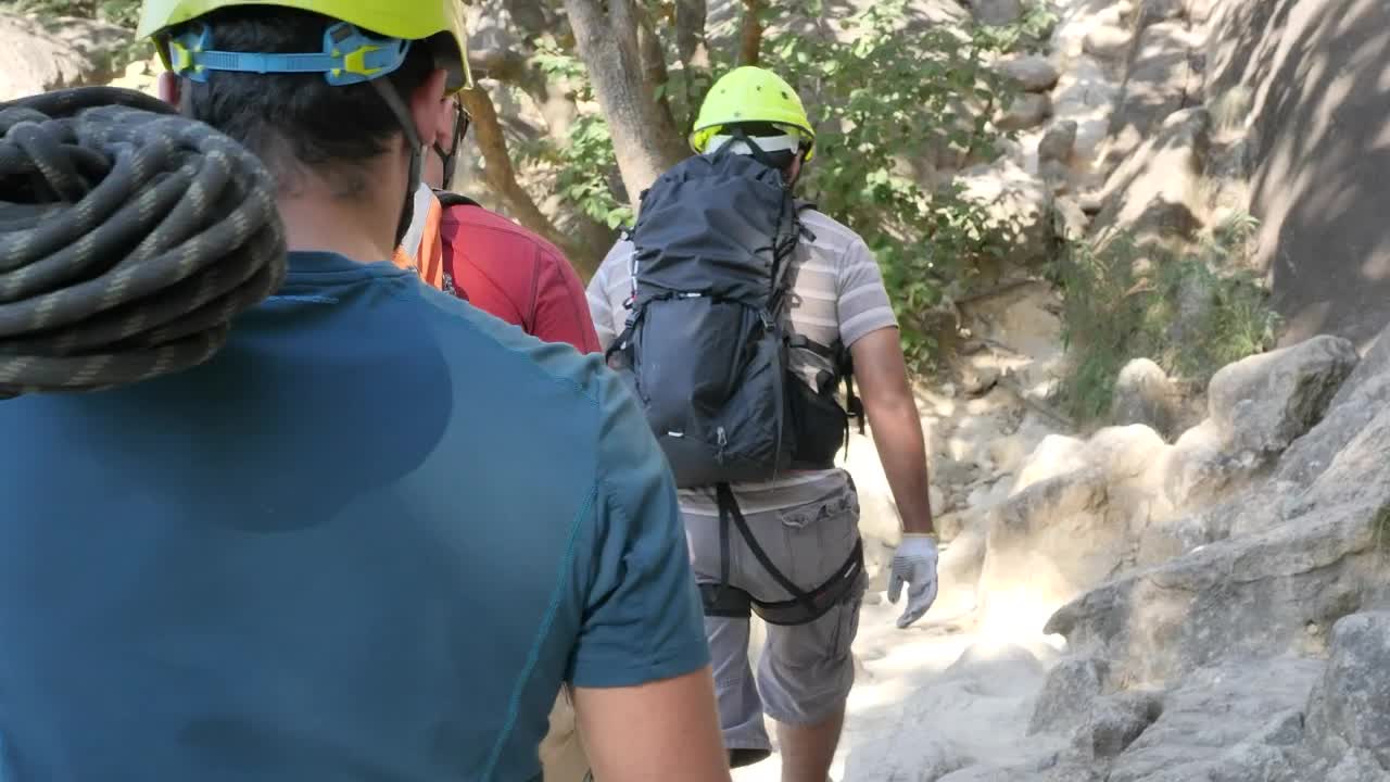 Stock Video Mountaineers Walking Around A Mountain In Nature Live Wallpaper