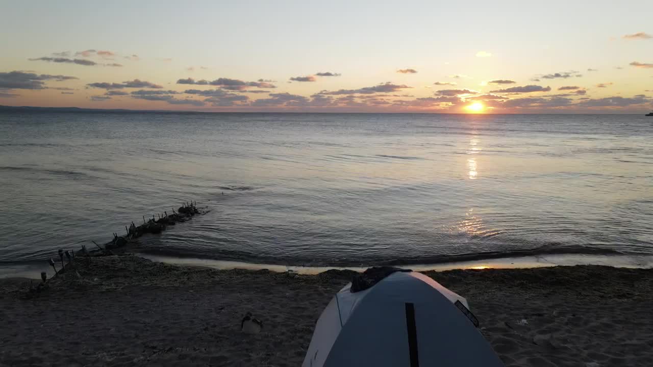 Stock Video Moving Through The Air On A Beach During Sunset Live Wallpaper
