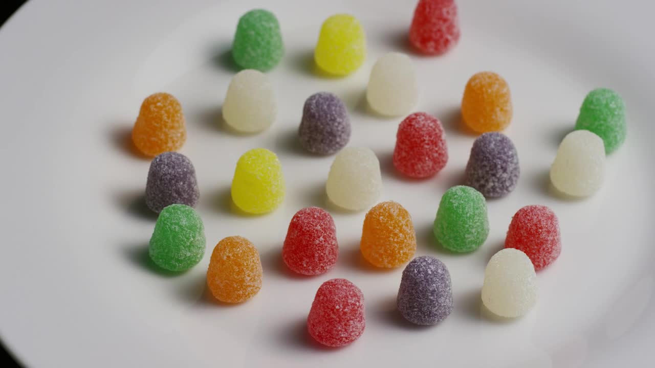Stock Video Multicolor Gummys Rotating On A Plate Live Wallpaper