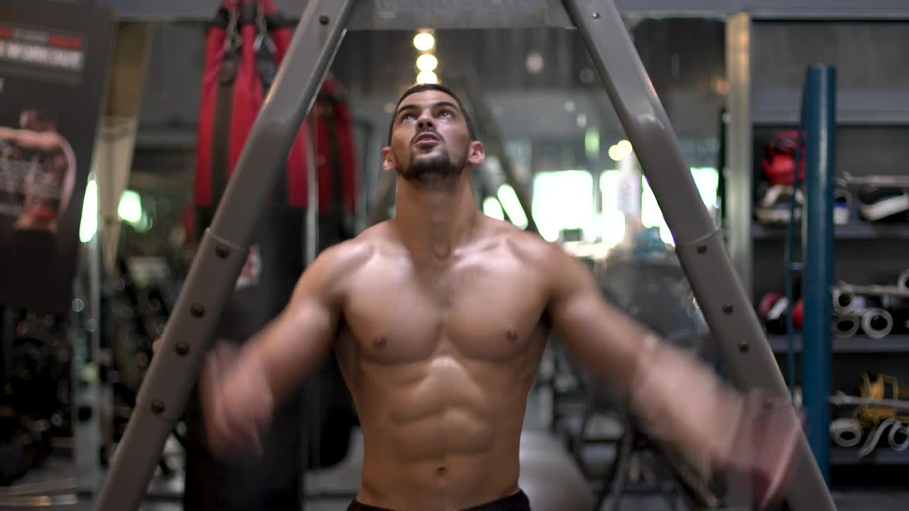 Stock Video Muscular Man Exercising In A Gym Live Wallpaper