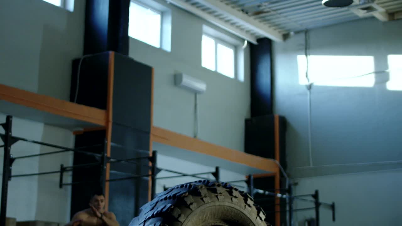 Stock Video Muscular Man Jumping A Tire In The Gym Live Wallpaper