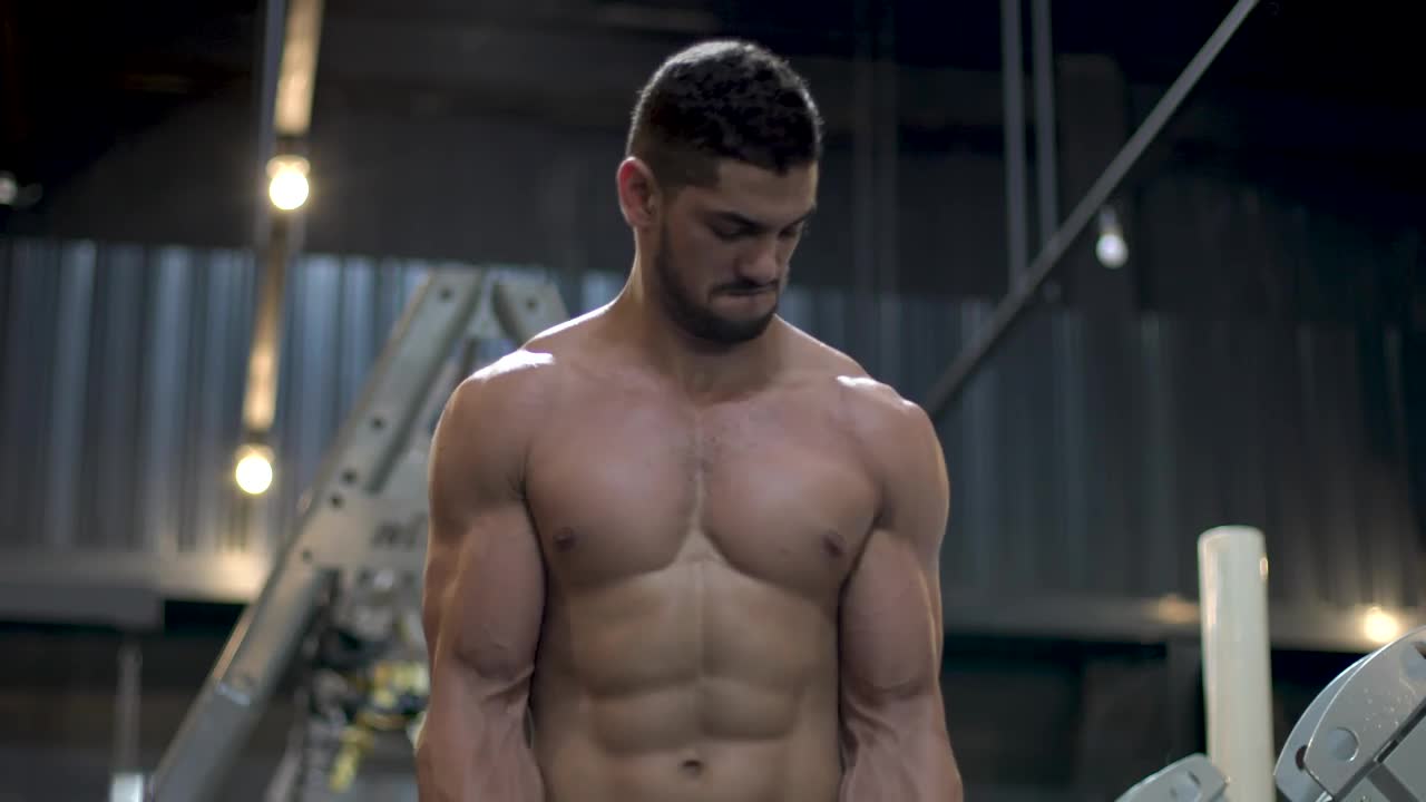 Stock Video Muscular Man Working Out With A Dumbbell Live Wallpaper