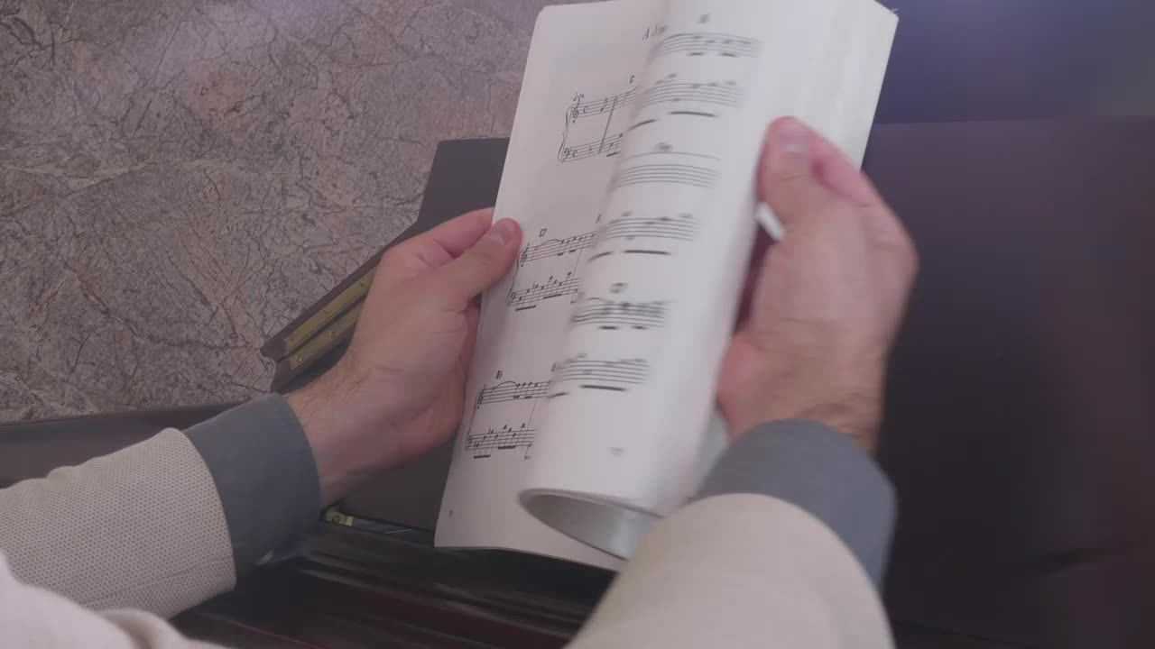 Stock Video Musician Looking For A Page In A Score Book Live Wallpaper