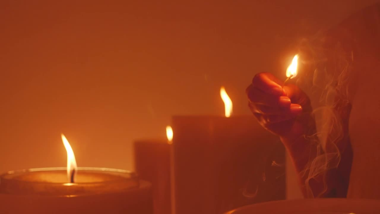 Stock Video Mysterious Woman Lighting A Huge Candle Live Wallpaper