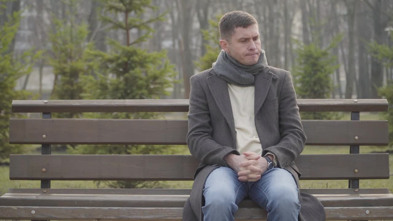 Stock Video Nervous Man Sits On Park Bench Waiting Live Wallpaper