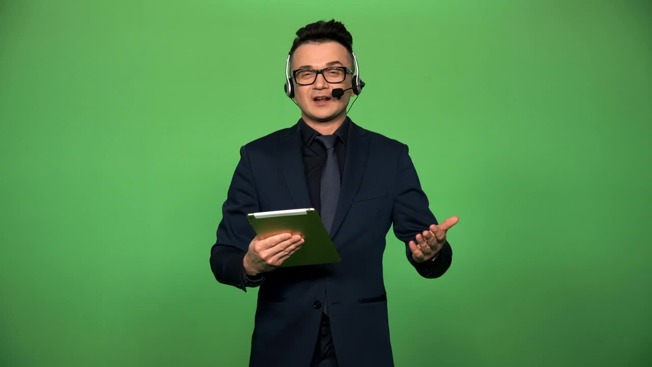 Stock Video Newscaster With Tablet And Headset Speaking Live Wallpaper
