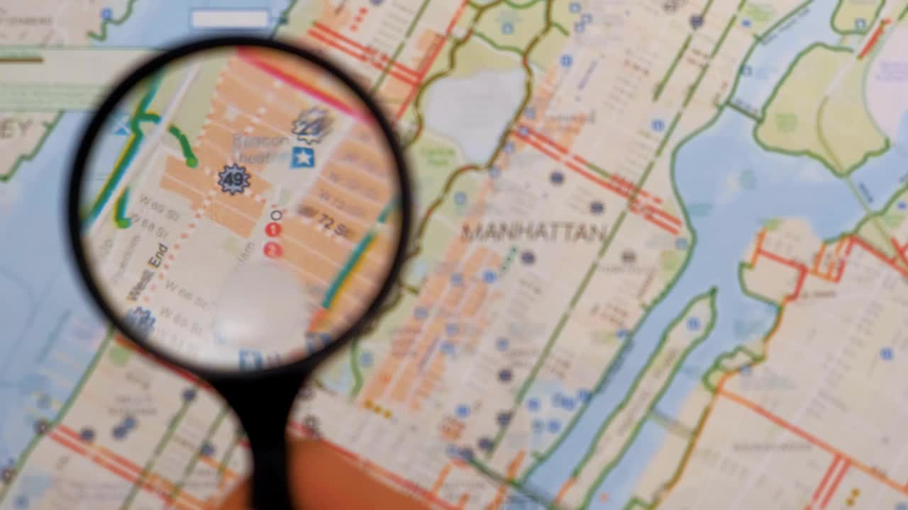 Stock Video Observing With A Magnifying Glass On A Map Of Manhattan Live Wallpaper