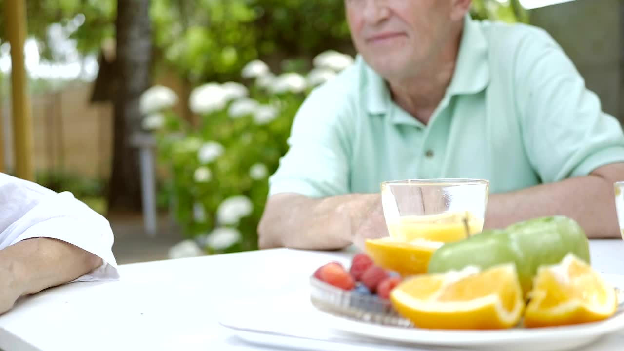 Stock Video Old Couple Holding Hands At The Table Live Wallpaper
