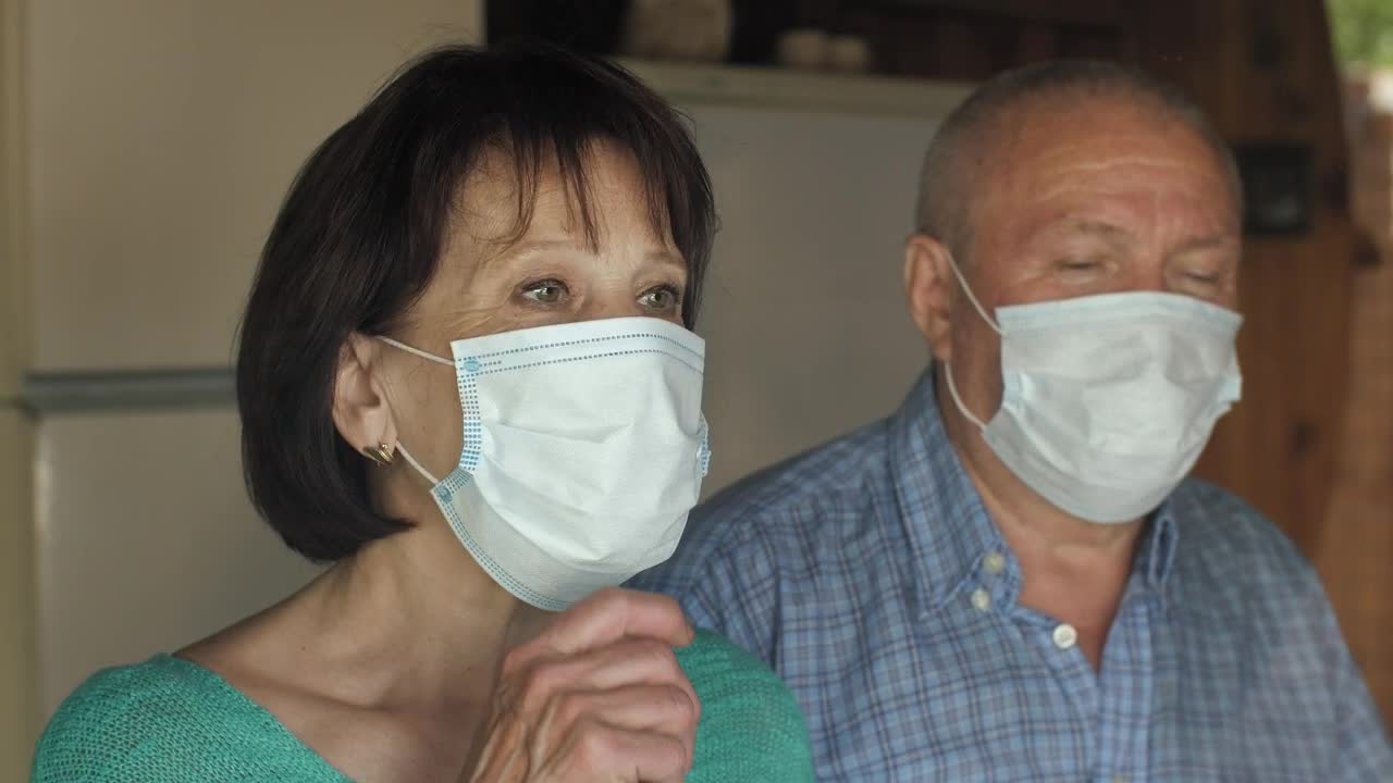 Stock Video Old Couple Taking Off Their Masks At Home Live Wallpaper
