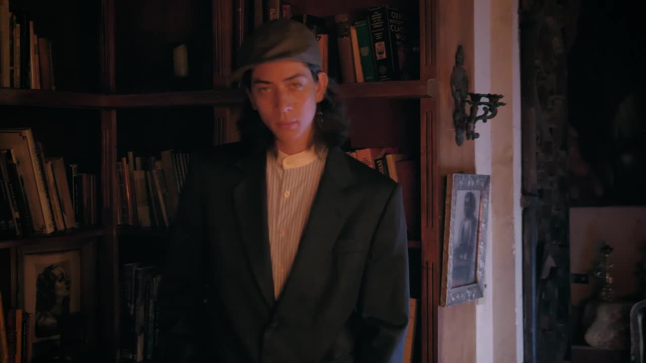 Stock Video Old Fashion Model Smoking In An Old Bookstore Live Wallpaper